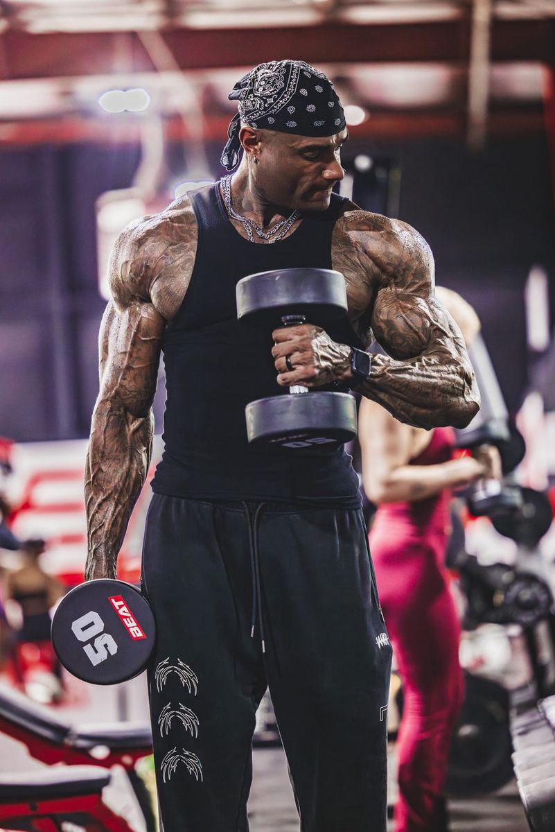 Coach Jae curling a dumbbell